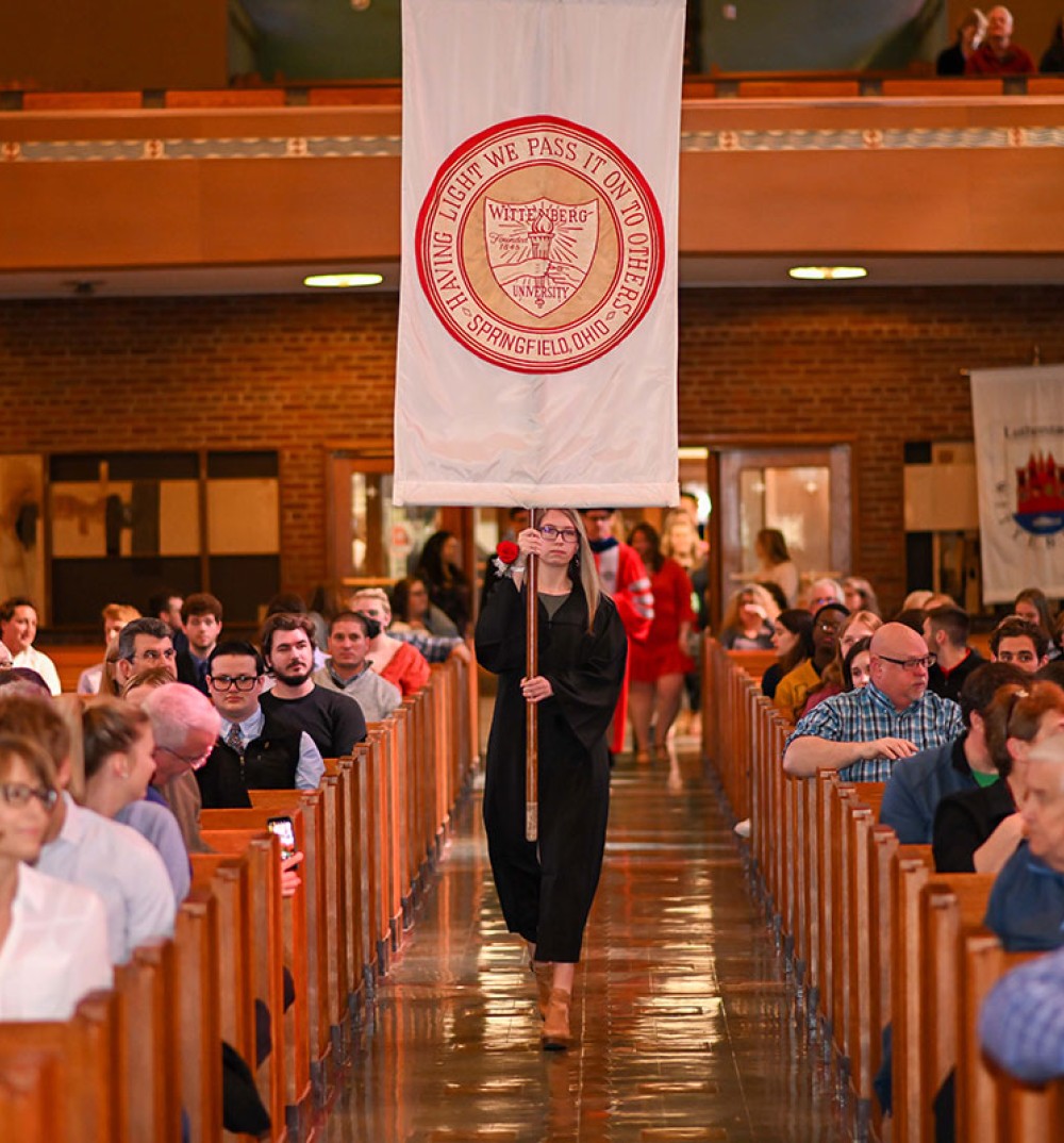 Wittenberg Student with Banner at Honors Convocation