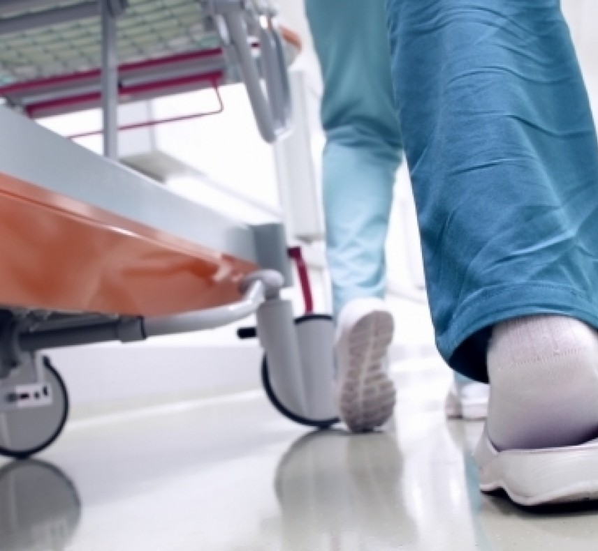 view of nurses feet walking down hallway