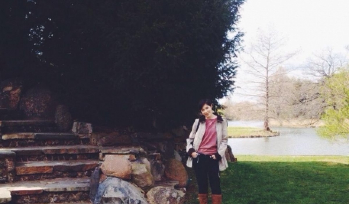 A student standing in a park in Germany