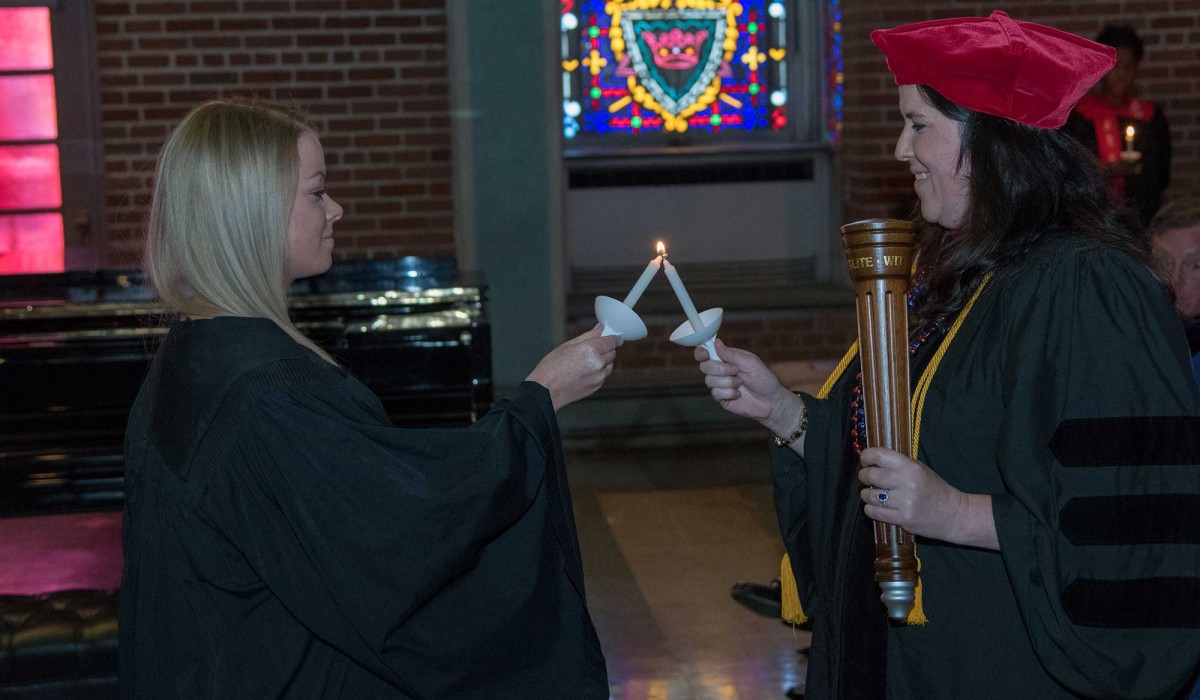 Dr. Katie Warber passes her light to a student