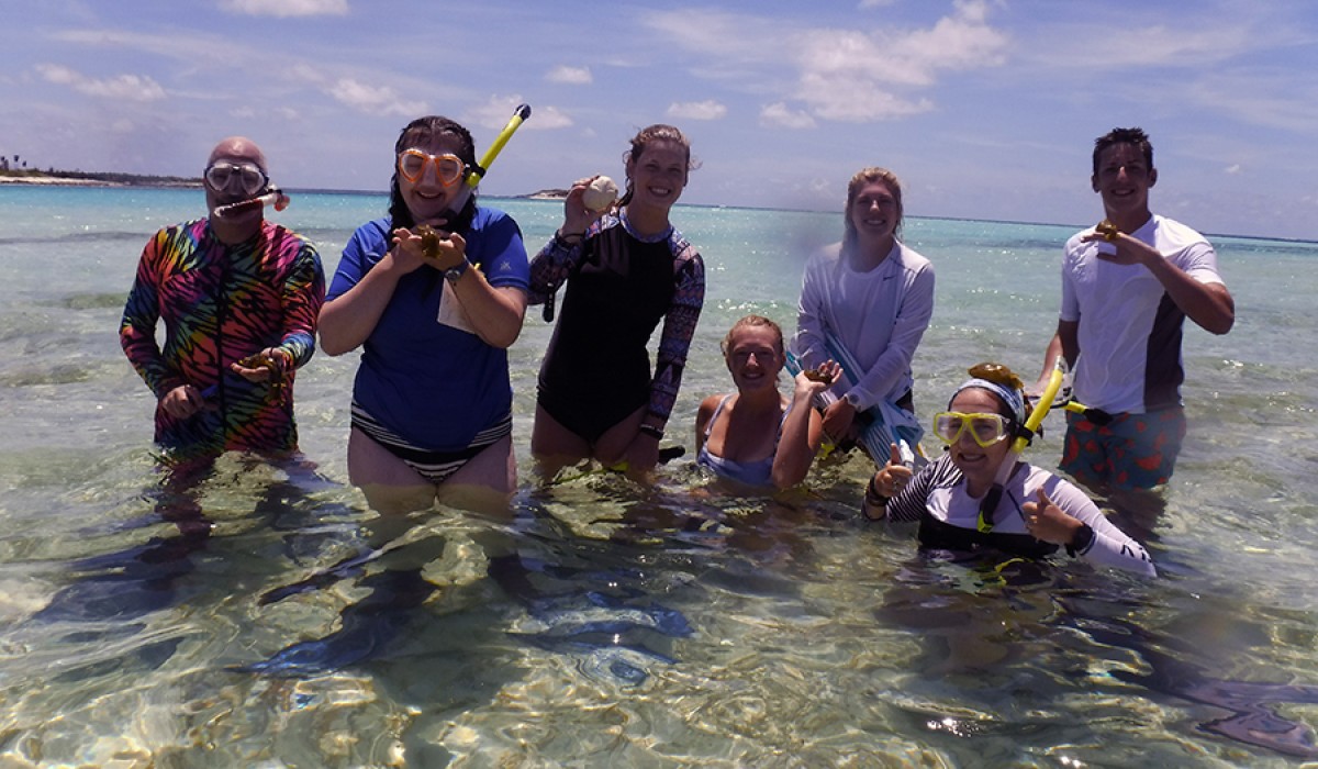 Students holding slimy sea hares