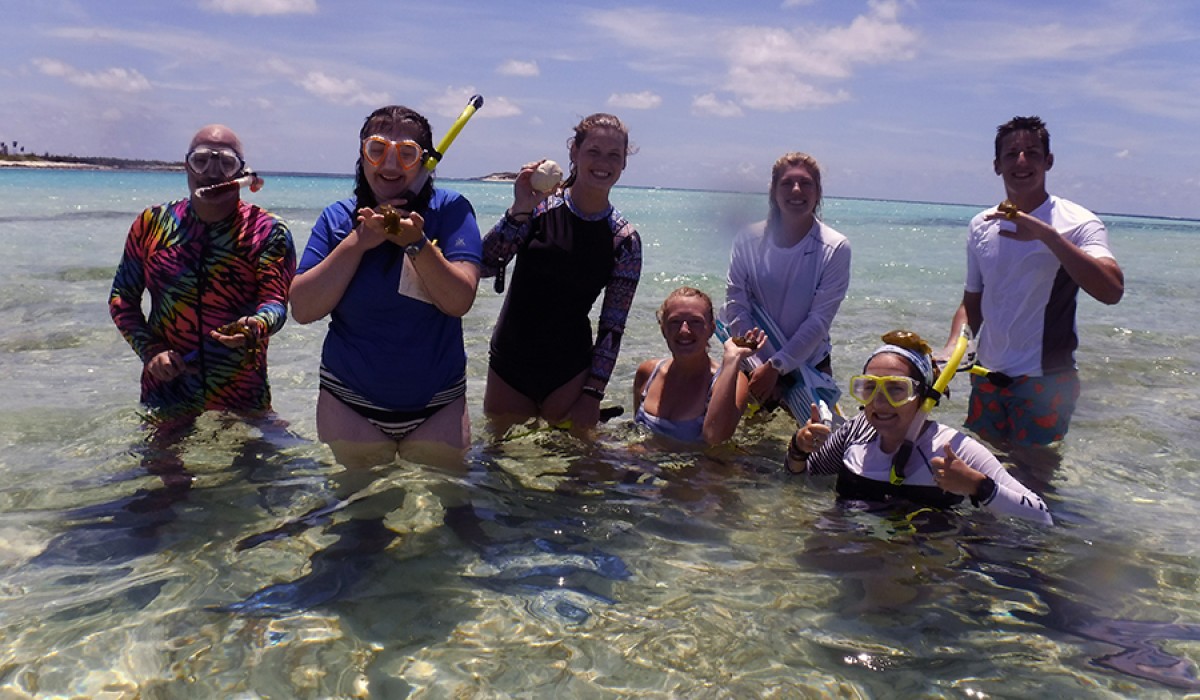 Students holding slimy sea hares