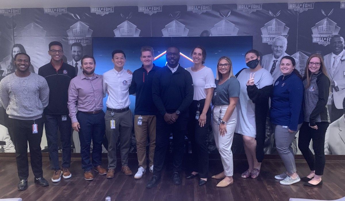 Katie Hiestand ’22 (5th from right) with Hall of Famer Marshall Faulk