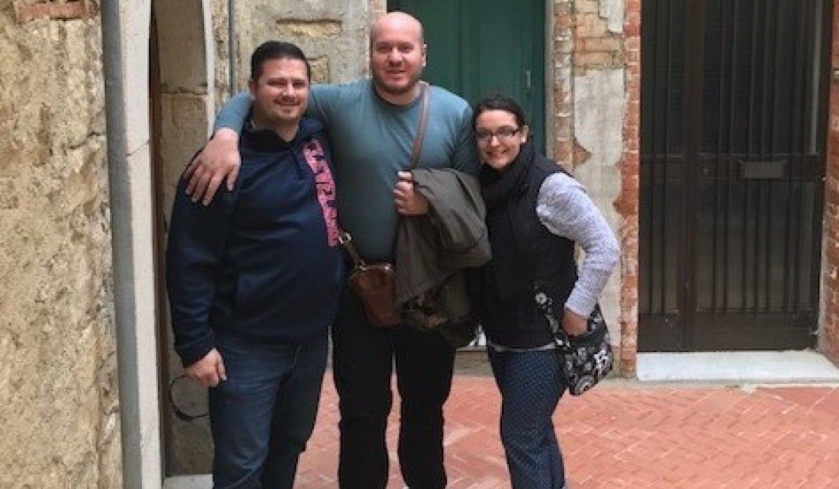Mike ’99 (left) and Bethany Schlater DeMassimo ’04 (right) with Giovanni Daniele in front of Mike’s grandmother’s street in San Giovanni in Galdo, Molise, Italy