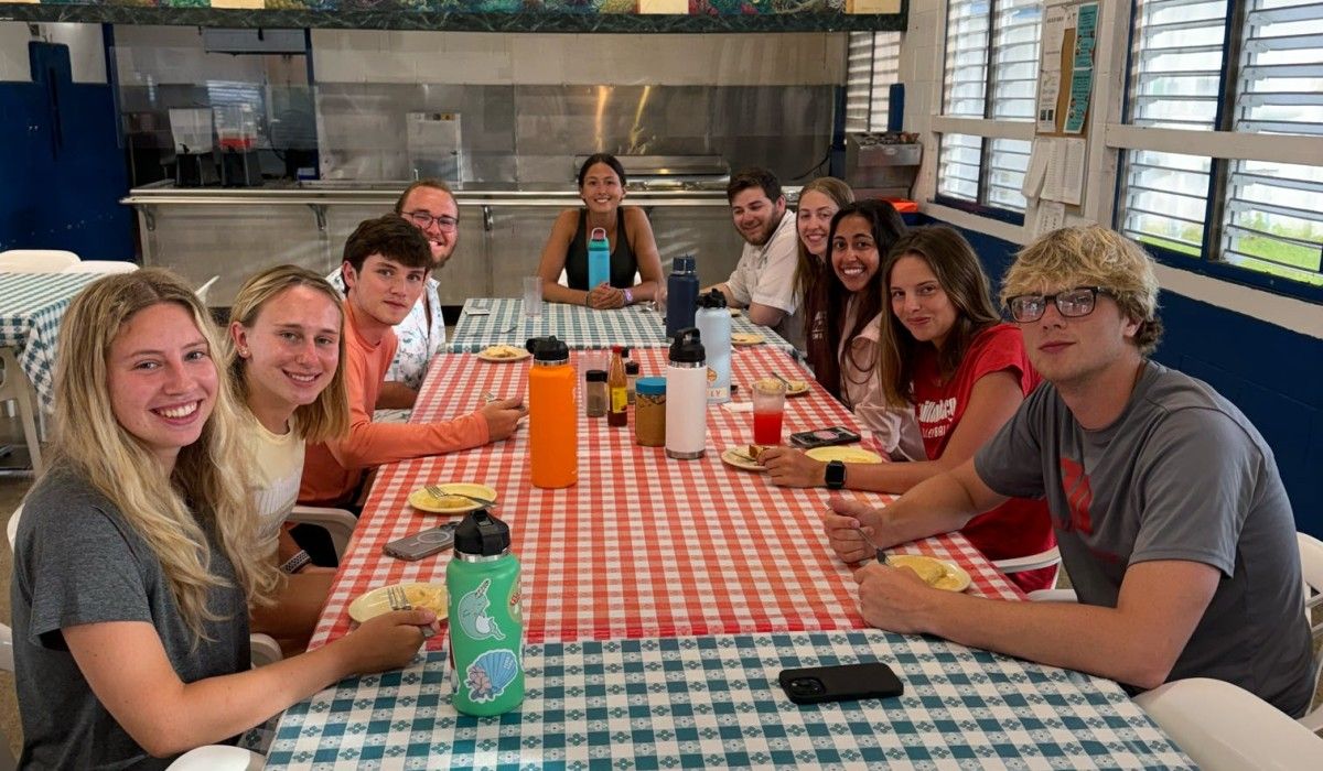 students enjoying guava duff, a Bahamian dessert