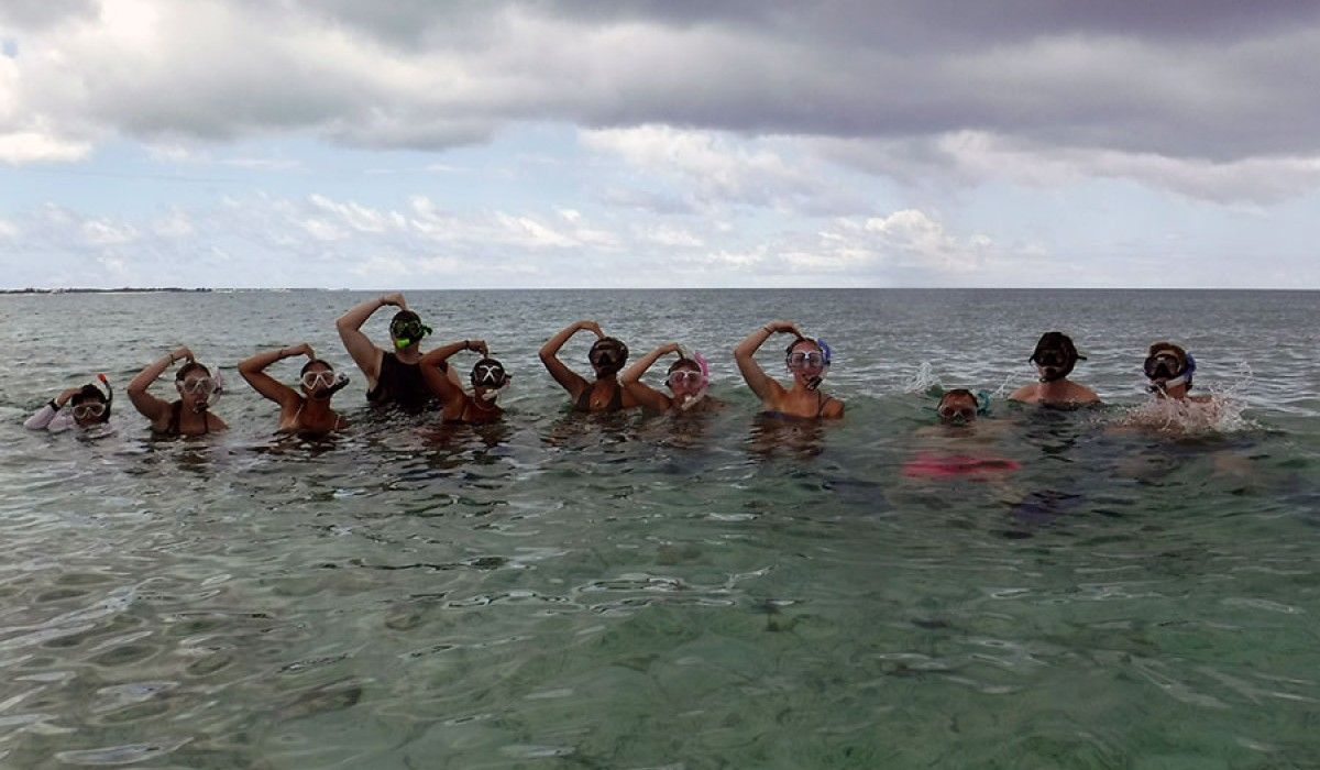 Students give the OK signal before swimming to the wall