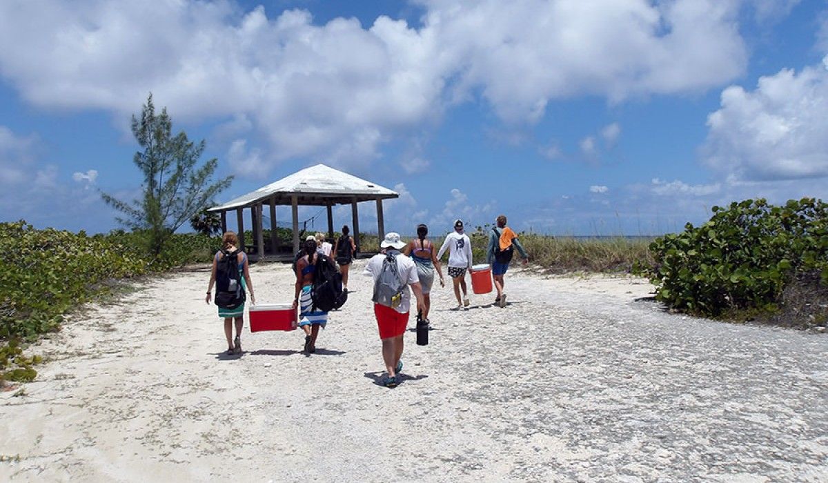 Students carry lunch down to the Grotto