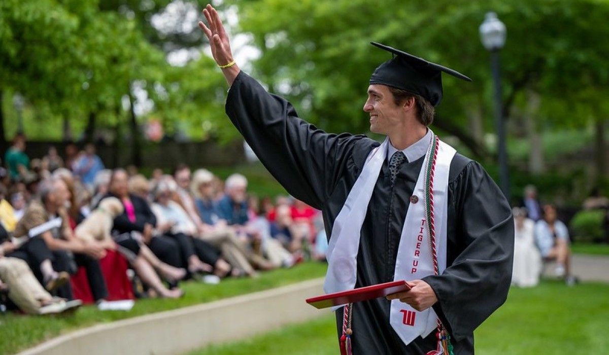 Graduate waves during Commencement 2024