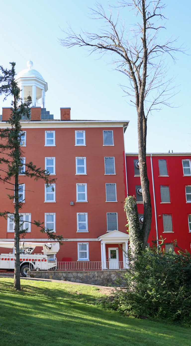 Myers Hall being repainted its cherished red in 2026.